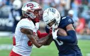 Malcolm Britt pushes off a Western Kentucky player to advance the ball for the Monarchs. 图Chuck Thomas/ODU